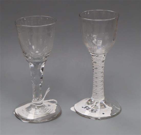 An 18th century wine glass with opaque double-twist stem and moulded funnel bowl and a similar glass with facet-cut stem and rim, H 5in